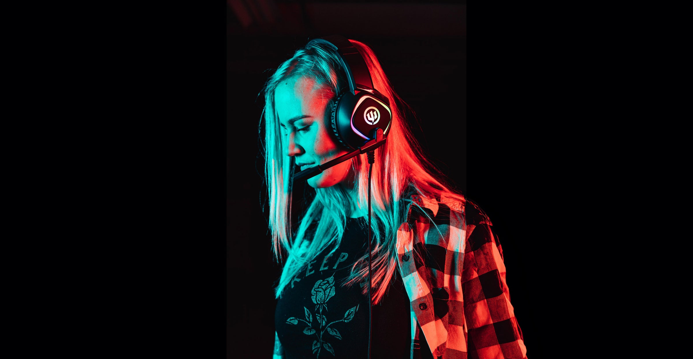 Woman wearing gaming headphone on black background