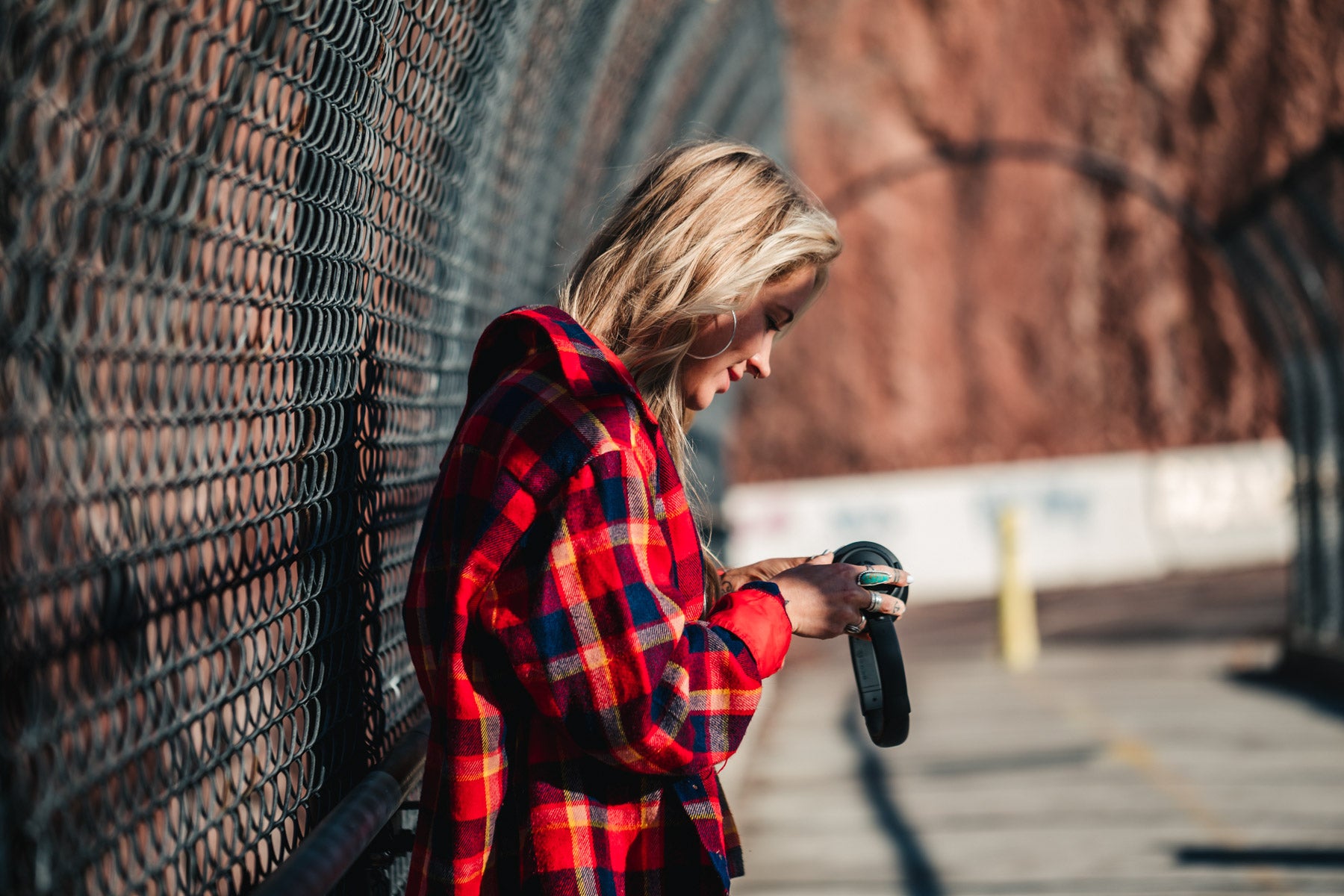 Endo Headphone held by woman in red flannel