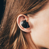 Closeup of Arq True Wireless Earbud in model's ear